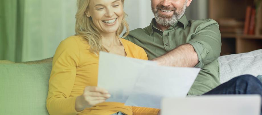 Couple smiling at financial statements